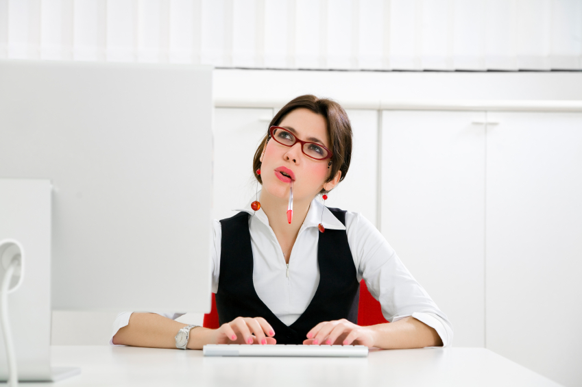 Young businesswoman in office typing on computer